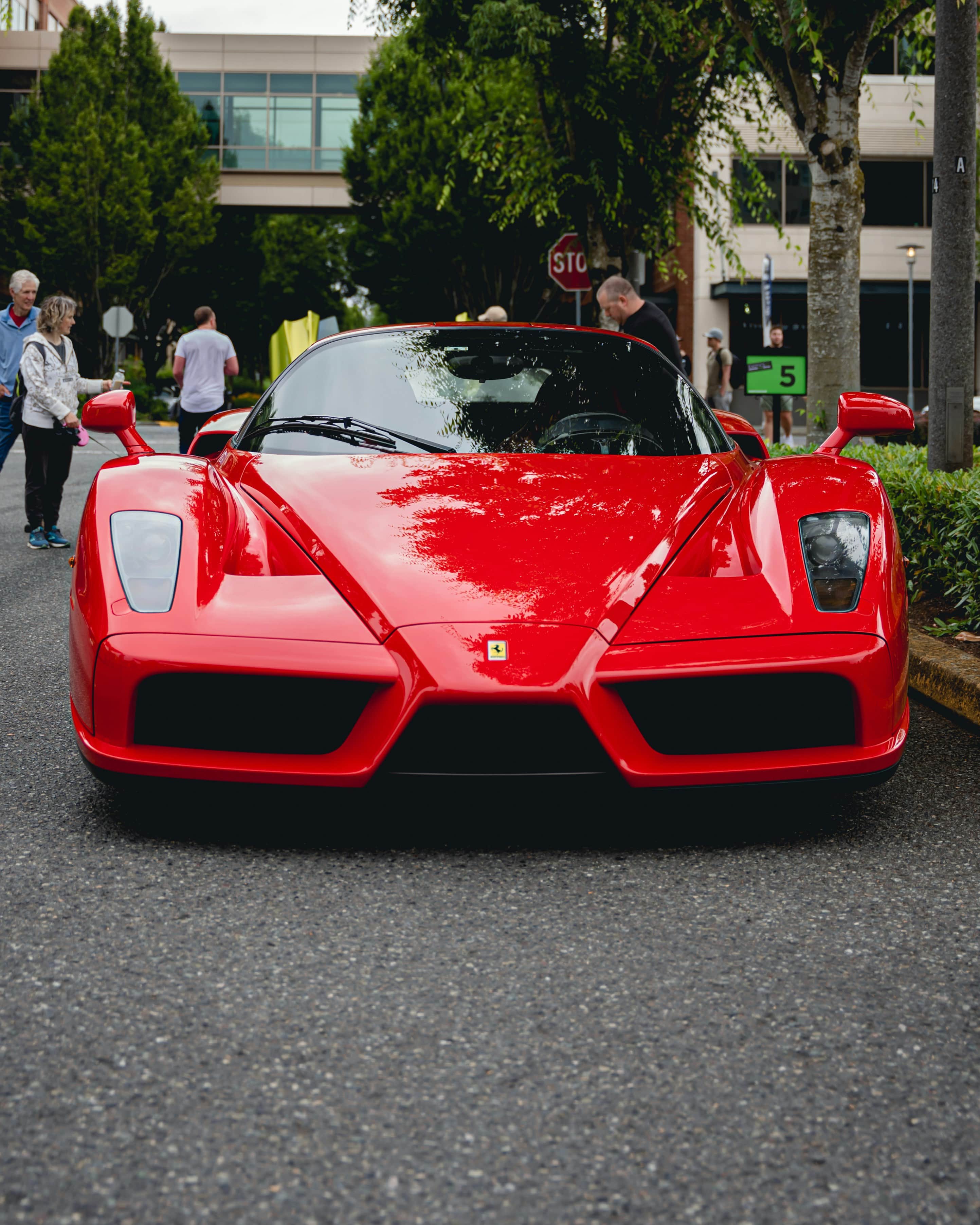 Ferrari supercar launch event with red car on display